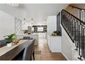 Modern kitchen and dining area with new appliances at 9962 W 77Th Ave, Arvada, CO 80005