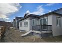 New construction home shows backyard with small porch and under-porch storage in Colorado at 17136 W 92Nd Loop, Arvada, CO 80007
