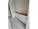 White bathroom vanity with gray tile floors awaits final fixtures in this new construction home at 17136 W 92Nd Loop, Arvada, CO 80007