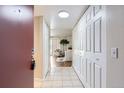 Inviting hallway features tiled floors, ample closet space, and leads into a bright, open living area at 14006 E Stanford Cir # K04, Aurora, CO 80015