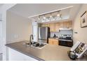 Efficient kitchen design features modern stainless steel appliances, practical countertops, and ample lighting at 14006 E Stanford Cir # K04, Aurora, CO 80015