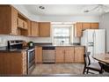 Functional kitchen featuring modern appliances, ample cabinet space, and a bright window over the sink at 5351 S Cody St, Littleton, CO 80123