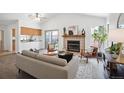 Bright living room boasts a fireplace, vaulted ceilings, and sliding glass doors to backyard at 5351 S Cody St, Littleton, CO 80123