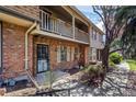 This townhome features a brick facade and a cozy balcony above the main entrance at 7101 W Yale Ave # 3403, Denver, CO 80227