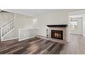 Bright living room features a cozy fireplace, wood floors, and an open layout at 7101 W Yale Ave # 3403, Denver, CO 80227