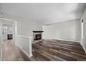 Open living room featuring modern flooring and a cozy fireplace at 7101 W Yale Ave # 3403, Denver, CO 80227