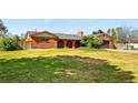Charming brick home with manicured lawn, two-car garage, arched brick entryway, and mature landscaping at 14793 E Hampden Pl, Aurora, CO 80014