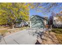 Two-story house with green exterior, driveway, and mature trees at 13942 Jackson St, Thornton, CO 80602