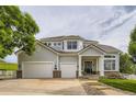 Charming two-story home with a three-car garage, landscaped yard, and inviting covered porch at 7866 Witney Pl, Lone Tree, CO 80124