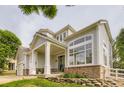 Close up showing a welcoming covered porch with classic columns and well-maintained landscaping at 7866 Witney Pl, Lone Tree, CO 80124