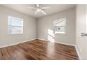 Simple bedroom with wood floors and two windows at 1250 S Tennyson St, Denver, CO 80219