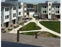 Desirable neighborhood showcasing modern townhomes, a walking path, and well maintained green spaces at 14223 Currant St, Broomfield, CO 80020