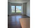 Spacious living room featuring hardwood floors and plenty of natural light from large windows at 14223 Currant St, Broomfield, CO 80020