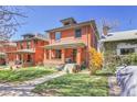 Charming brick two story house with a well-manicured lawn and inviting front porch at 161 S Pearl St, Denver, CO 80209