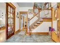 Inviting foyer with hardwood floors, a classic staircase, and beautiful wood trim at 161 S Pearl St, Denver, CO 80209