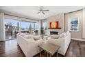Bright living room with large windows, fireplace, and modern furnishings for comfortable living at 8440 Rush Creek Ave, Littleton, CO 80125