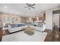 Stylish open-concept living space featuring hardwood floors, modern decor, and plenty of natural light at 8440 Rush Creek Ave, Littleton, CO 80125