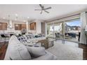 Open concept living space with sleek floors, oversized sliding glass doors, and modern kitchen at 8440 Rush Creek Ave, Littleton, CO 80125