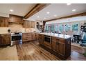 Spacious kitchen featuring custom wood cabinets, island with countertop, and stainless steel appliances at 351 N Saddle Dr, Idaho Springs, CO 80452