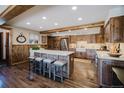 Charming kitchen features an island with seating and modern appliances, creating a warm and inviting space at 351 N Saddle Dr, Idaho Springs, CO 80452