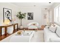 Bright living room with hardwood floors, white walls, and modern furnishings at 1501 S Youngfield Ct, Lakewood, CO 80228