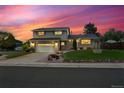 Charming two-story home featuring a two-car garage and lush, landscaped front yard at 13266 Canopus Dr, Lone Tree, CO 80124