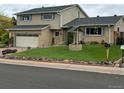 Inviting two-story home with a lush lawn and charming exterior details at 13266 Canopus Dr, Lone Tree, CO 80124