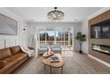 Bright living room with large windows, stylish furniture, and a modern fireplace feature at 180 N Edge Cliff St, Castle Rock, CO 80104