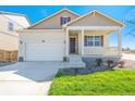 Beautiful beige single-Gathering home offers a two-car garage and a welcoming covered front porch at 817 Ledge St, Lochbuie, CO 80603
