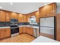 Updated kitchen features stainless steel appliances, stone countertops and patterned backsplash at 5481 E Tennessee Ave, Denver, CO 80246