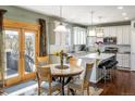 Bright kitchen with a breakfast nook, center island with bar stools, and stainless steel appliances creates a gourmet culinary space at 1870 Alpine Dr, Erie, CO 80516