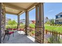 Charming front porch featuring stone columns and views of the community at 764 N Quatar St, Aurora, CO 80018