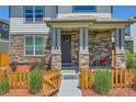 Inviting front porch with stone columns and landscaping detail at 764 N Quatar St, Aurora, CO 80018