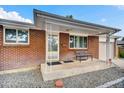Inviting front porch with brick facade and a cozy seating area, perfect for relaxing outdoors at 61 S 17Th Avdr, Brighton, CO 80601