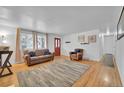 Bright living room with hardwood floors, large windows, and stylish furnishings, creating a welcoming atmosphere at 61 S 17Th Avdr, Brighton, CO 80601