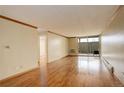 Spacious living room with hardwood floors, base and crown molding, leading to a private patio at 4600 E Asbury Cir # 109, Denver, CO 80222