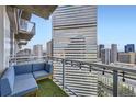 Cozy balcony with artificial turf, seating, string lights, and stunning city views at 2001 Lincoln St # 2213, Denver, CO 80202