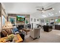 Sun-filled open-concept living area featuring a fireplace, skylights, and seamless access to the kitchen at 7552 Nikau Dr, Niwot, CO 80503