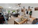 Bright and open living space with skylights, modern fan, and seamless flow to the well-equipped kitchen at 7552 Nikau Dr, Niwot, CO 80503