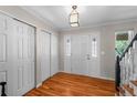 Bright foyer with hardwood floors, closet, and decorative front door with glass inlays at 6918 E Long Ave, Centennial, CO 80112