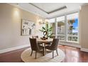 Bright dining area with hardwood floors, area rug, elegant lighting, and large windows with city views at 7600 Landmark Way # 1215, Greenwood Village, CO 80111