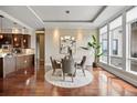 Bright dining area with hardwood floors, modern lighting, and an open layout to the kitchen at 7600 Landmark Way # 1215, Greenwood Village, CO 80111