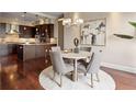 Open dining area with a round table, seating for four, and hardwood floors adjacent to the kitchen at 7600 Landmark Way # 1215, Greenwood Village, CO 80111