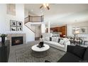 Spacious living room featuring a fireplace, plush seating, and an open floor plan perfect for entertaining at 7662 Bristolwood Dr, Castle Pines, CO 80108