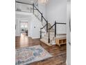 Stunning foyer showcasing a staircase, hardwood floors, and an open layout into other living spaces at 445 Brendon Ct, Castle Pines, CO 80108