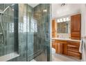 Modern bathroom features a glass-enclosed shower, wood cabinets, and sleek fixtures at 537 S Grape St, Denver, CO 80246