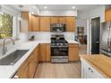 Well-equipped kitchen boasts stainless steel appliances, ample counter space, and wooden cabinets at 537 S Grape St, Denver, CO 80246