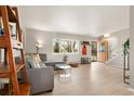 Bright living room features hardwood floors, a large window, and stylish furnishings, creating a warm and inviting atmosphere at 537 S Grape St, Denver, CO 80246