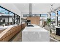 Bright and airy kitchen with a large island, modern appliances, and sleek wood cabinetry at 4752 Eliot St, Denver, CO 80211