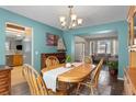 Bright dining room showcasing an elegant chandelier and seamlessly connecting to a living area at 17018 Carr Ave, Parker, CO 80134